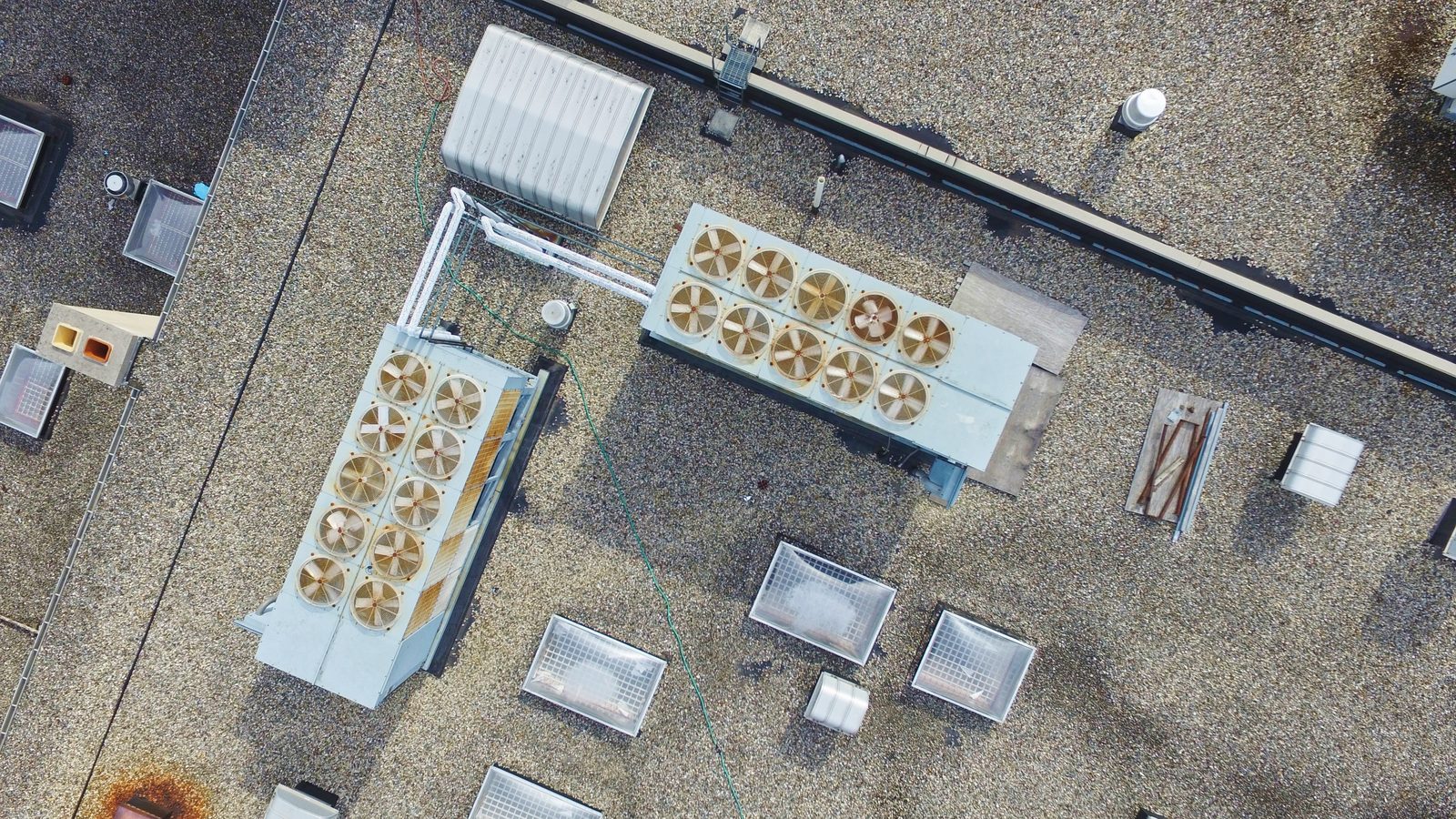 Aerial view of HVAC units on a gravel-ballasted commercial rooftop