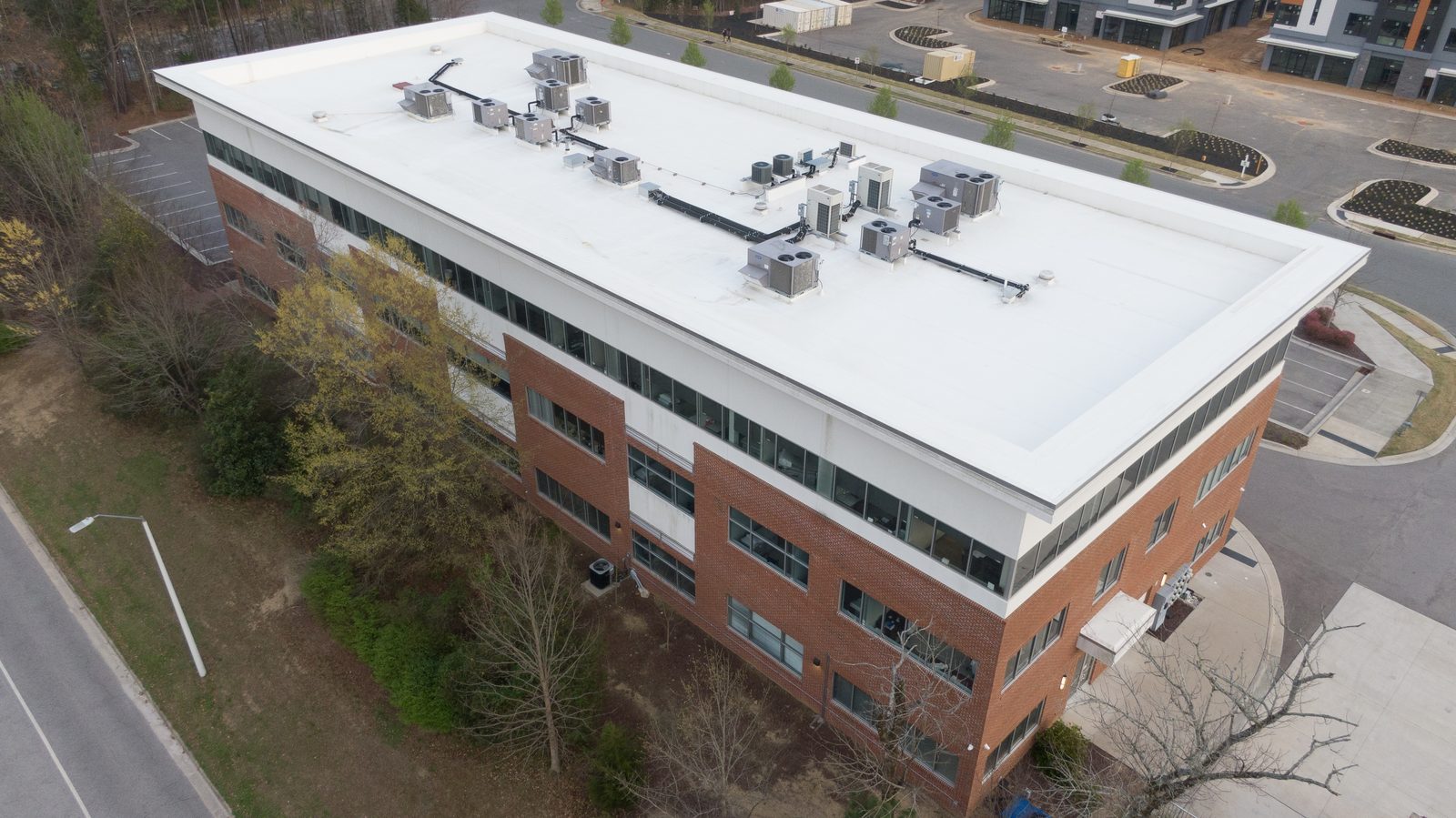 Aerial view of a white TPO commercial flat roof