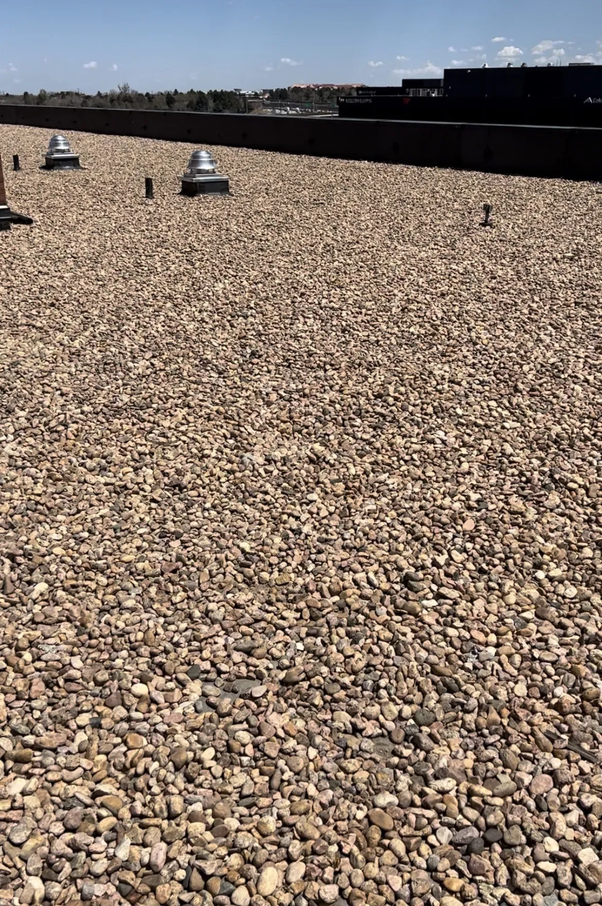 Ballasted flat roof covered in gravel before evaluation