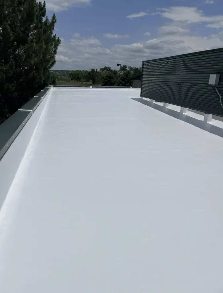 Narrow commercial flat roof section after white coating