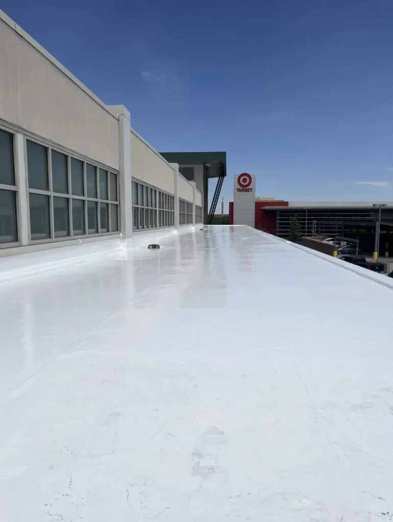 Bright white coated flat roof along a building parapet wall