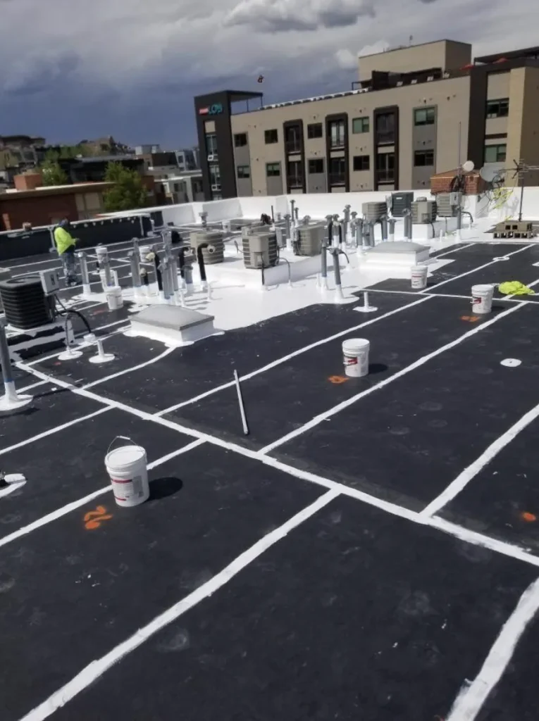 Black flat roof with white seam reinforcement during roof restoration