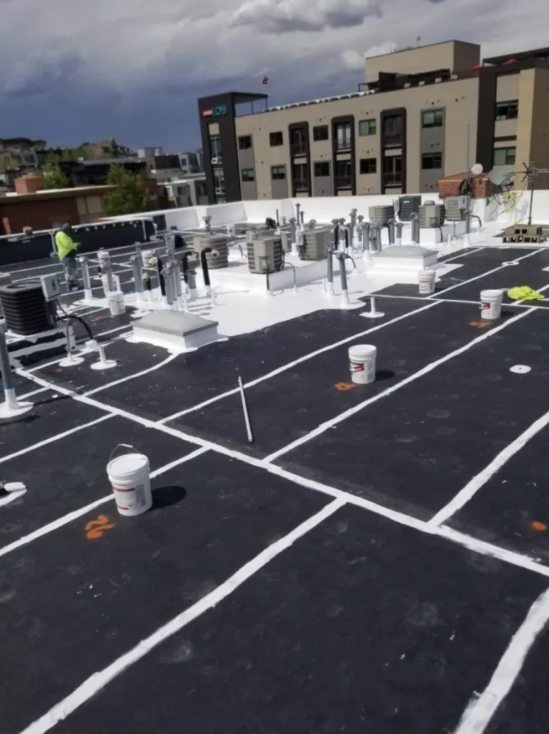 Black flat roof with white seam reinforcement during roof restoration