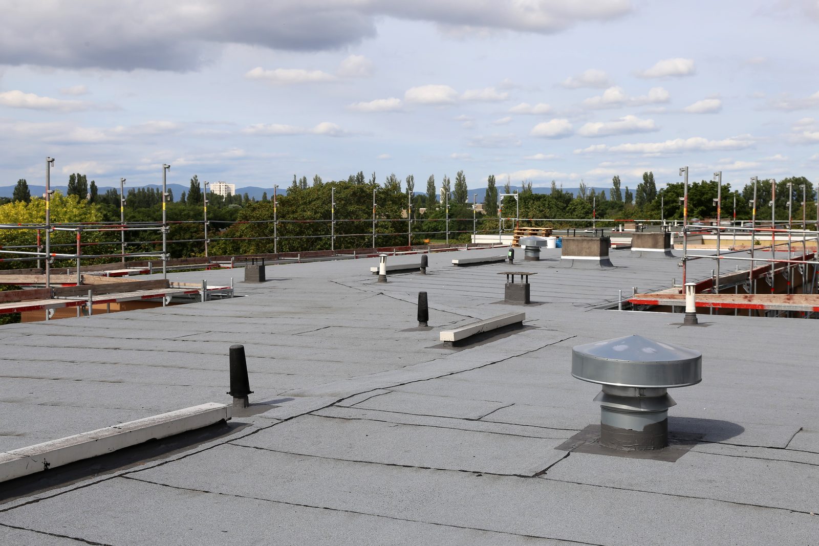 Crew sealing a large commercial flat roof
