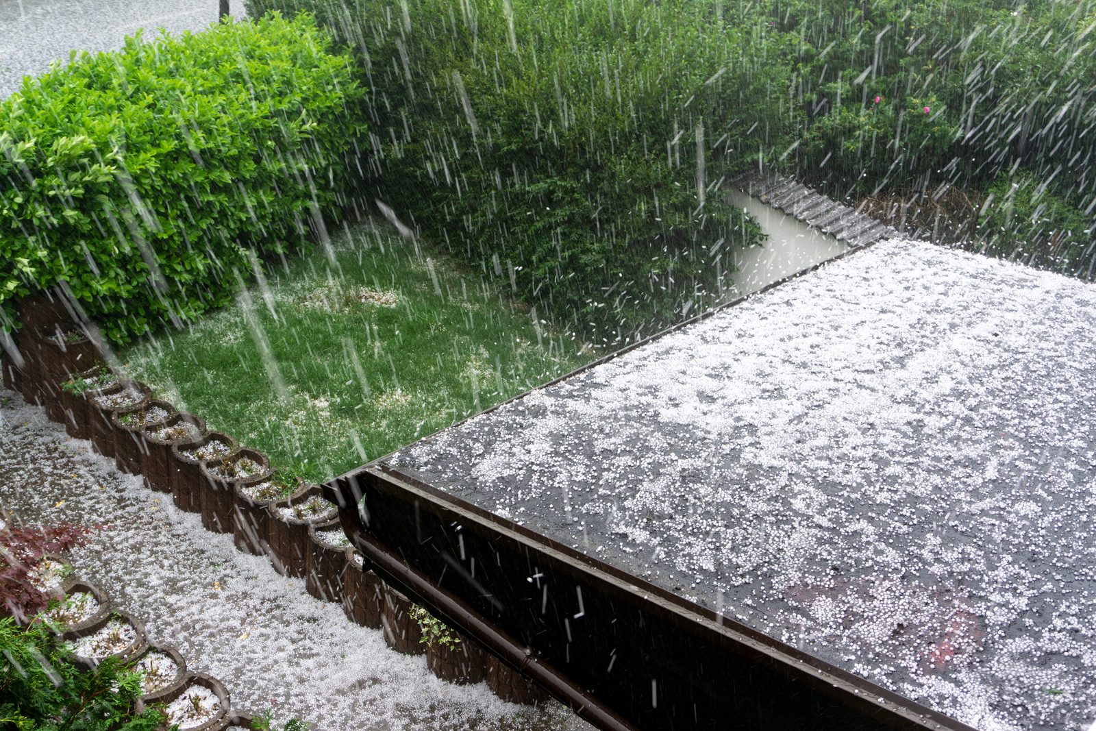 Hailstones falling on a roof during a storm
