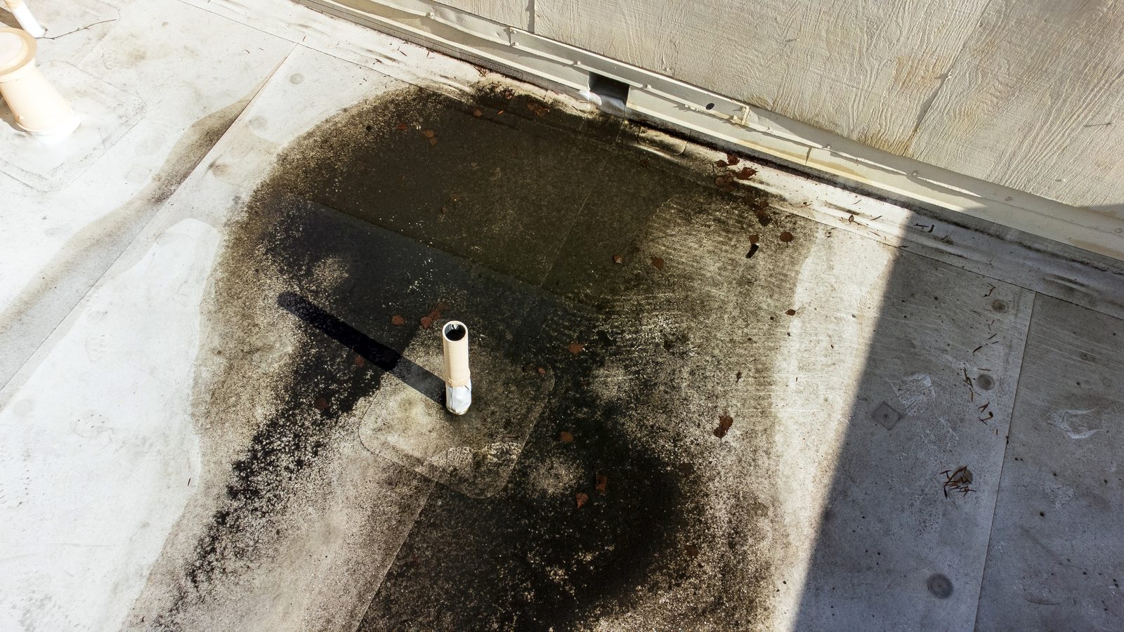 Ponding rainwater sitting on a flat commercial roof
