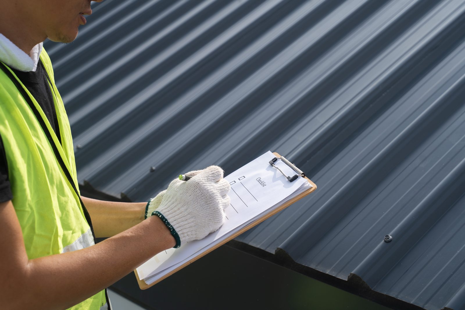 Inspector checking roof condition after a repair